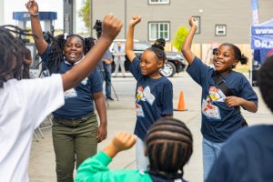 Kids girls hands up2024-09-30-MPO-The-Roux-Ribbon-Cutting_VJ30806